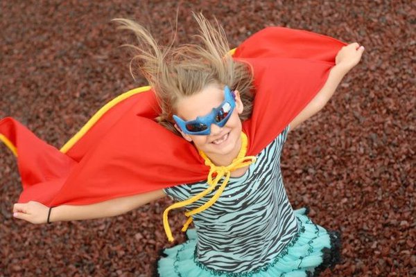 A picture shows a child in a cape.