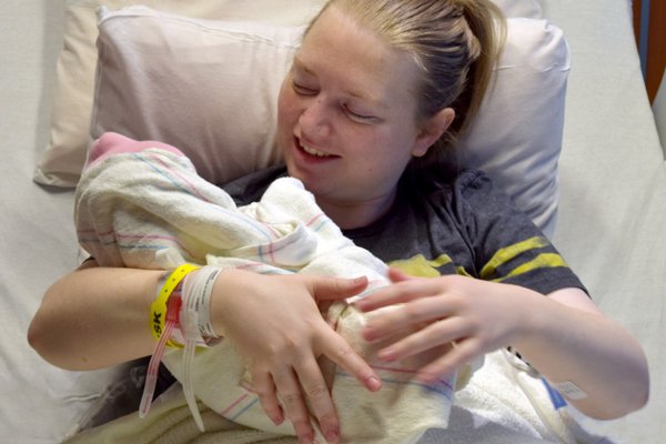 Bobbie holds Sydney, CoxHealth's first baby of 2018.