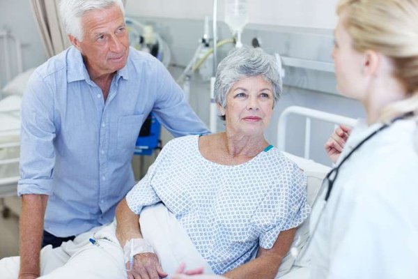 A man and woman listen to a provider.