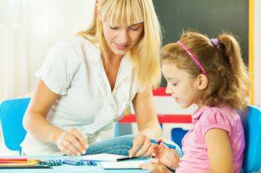 A woman and child sit together, representing the work Parents as Teachers staff will do.