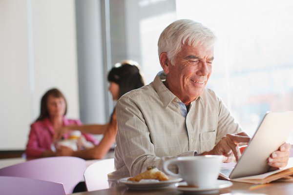 Man on tablet in cafeteria