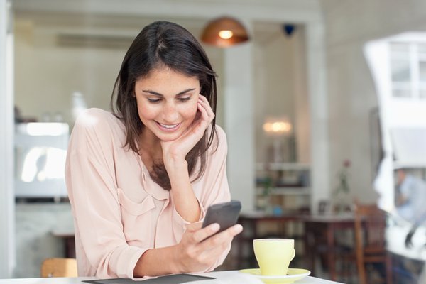 Women looking at her phone in kitchen