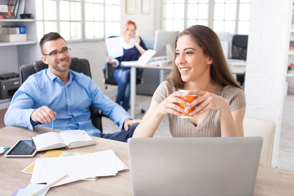 Two people discussing over a computer