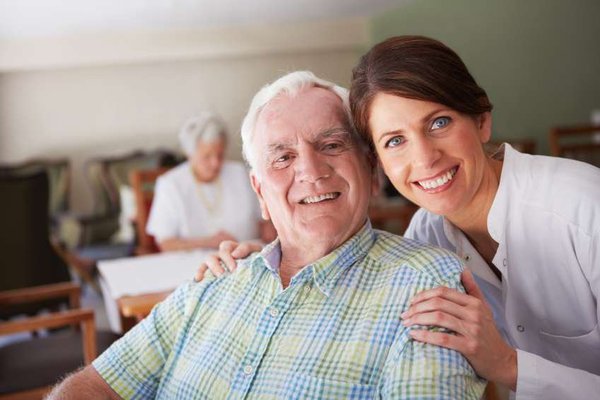 Two people smile at the camera.