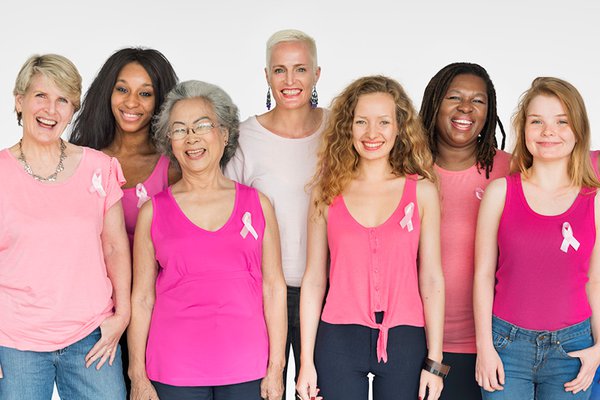 A group of women wears pink shirts.