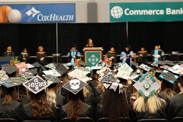 Students sit at Cox College's graduation.