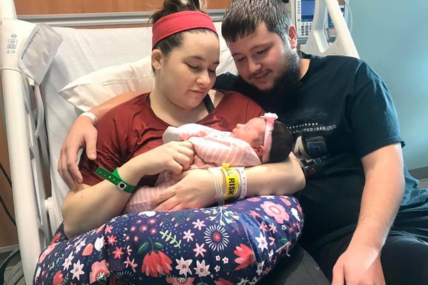 Parents Vivian and Bill Law hold their new baby, Lucy Belle.