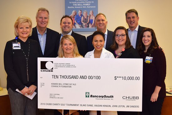 Group of cox health employees stand with a large check