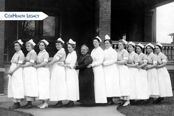 Ellen Burge, center, stands with a group of nurses.