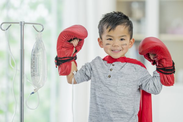 A photo shows a child with boxing gloves.