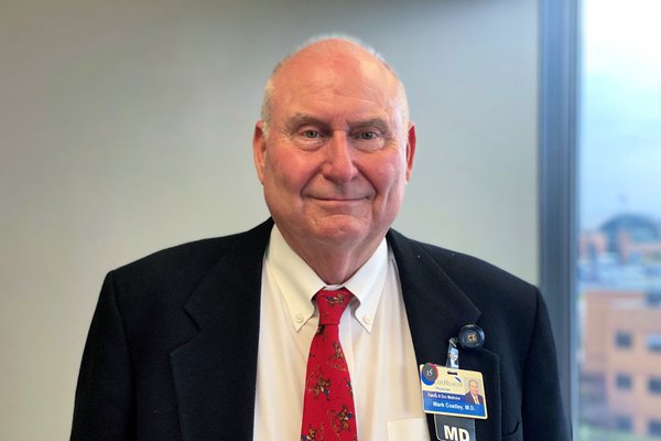 An image shows Dr. Costley in his office.