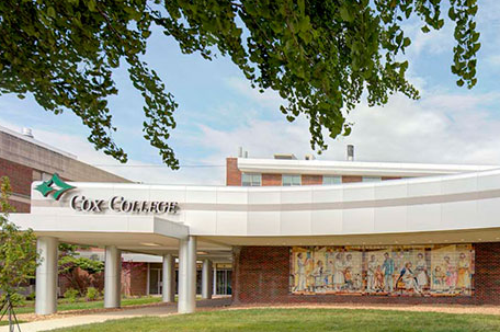 A photo shows the exterior of Cox College.