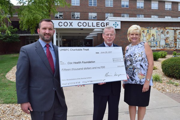 Cox Health members holding up a donation check