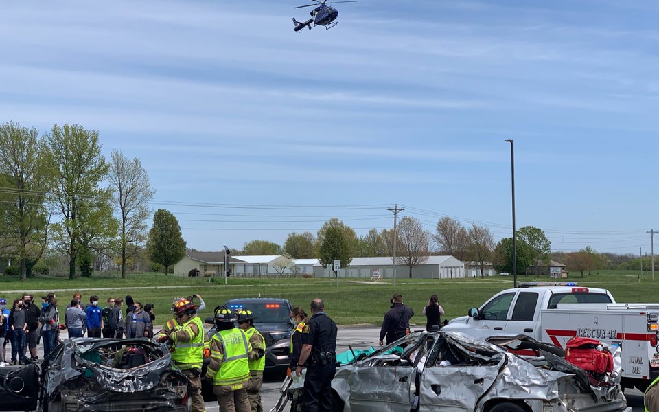 A scene from docudramas with wrecked cars, fire and police crews and a CoxHealth helicopter flying overhead.