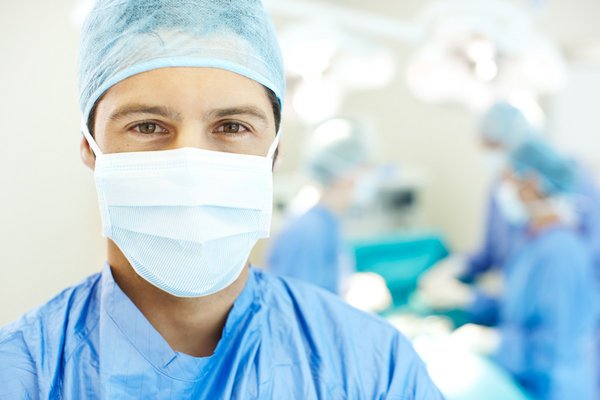 A health care provider wearing a mask and other protective gear looks into the camera.