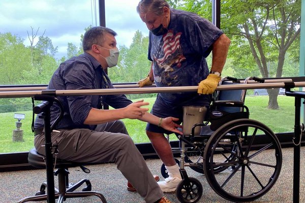 man with prosthetic leg doing physical therapy