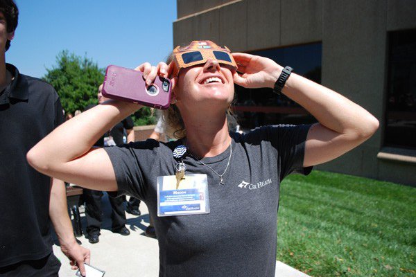 Cox Health staff member using special glasses to see the solar eclipse