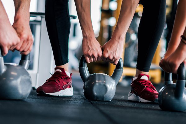 A photo shows several people working out at a gym.