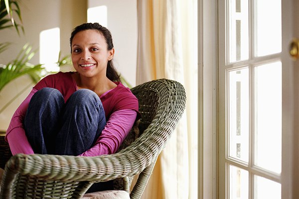 A woman sits in a chair.