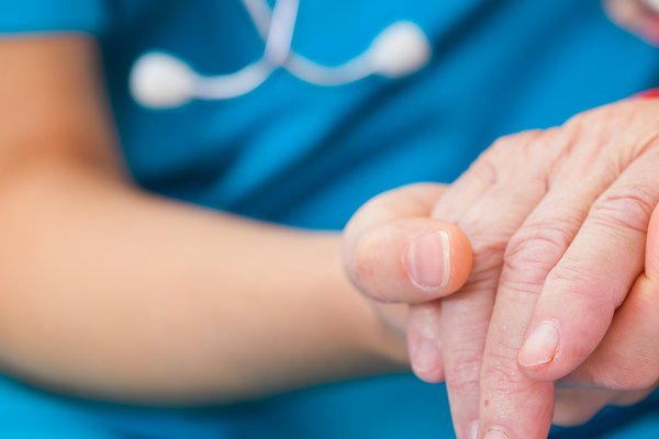 A nurse comforts a patient.