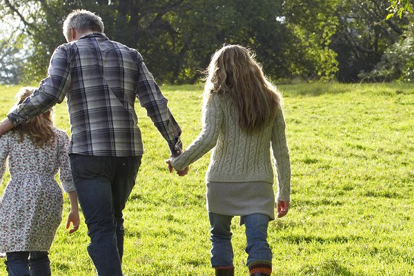 An image shows a family walking together.