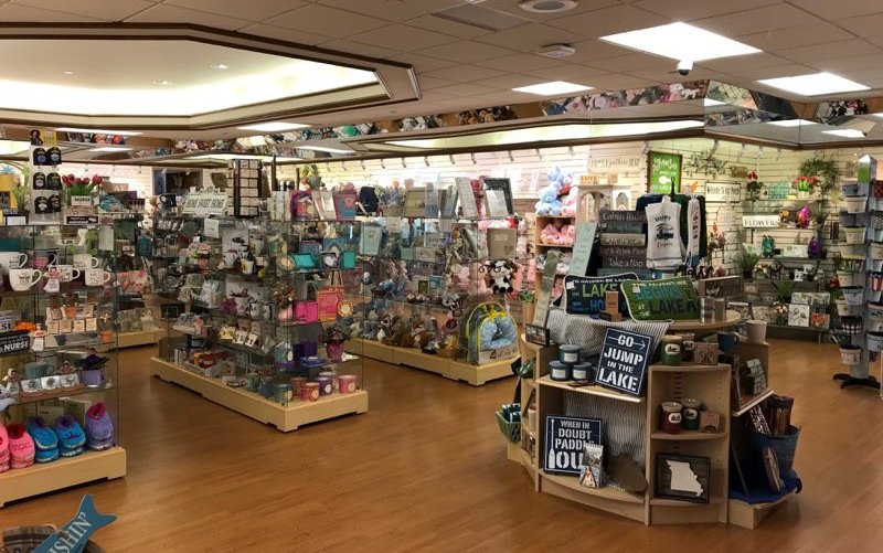 The inside of the gift shop at Cox South, with displays of coffee mugs, signs, clothing and other merchandise.