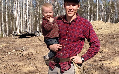 Dr Hansen with his son in the woods.