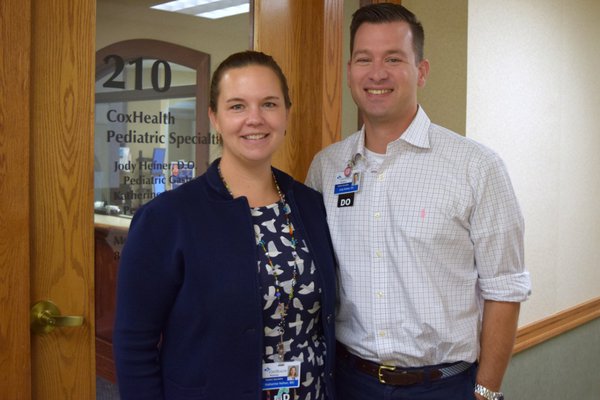 Dr. Jody and Dr. Kate Hefner pose outside their office.