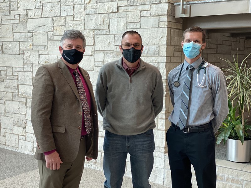 Dr. Randall Cross, Mathew Michaelson and Kelley Jenkins, nurse practitioner, pose for a photo.