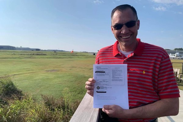 Mathew Michaelson stands with his certification paperwork.