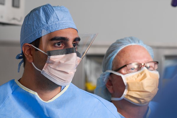 Dr. Kamyab and other doctor in scrubs and masks