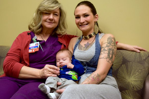 Mom and nurse holding baby boy.