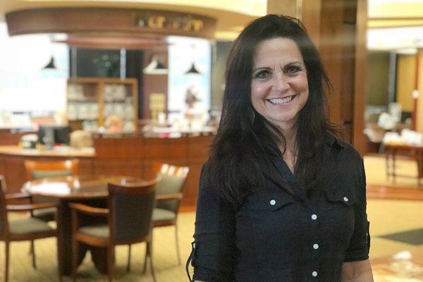 Marla Lucas poses in Hulston Cancer Center's lobby.