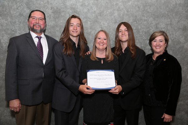 Kim and family accepting her award