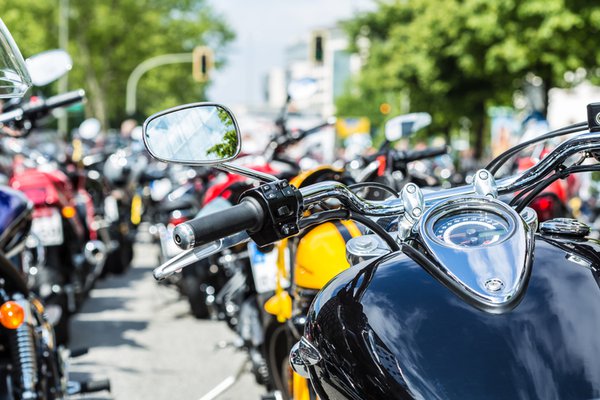 Multiple motorcycles parked on the street