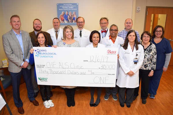 A group of CoxHealth and ONF leaders pose for a photo at the check presentation.