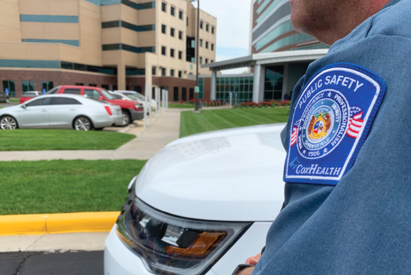 A Public Safety officer stands in front of Cox South.