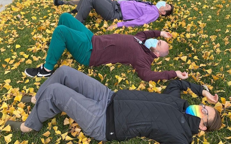 Residents laying on ground in leaves