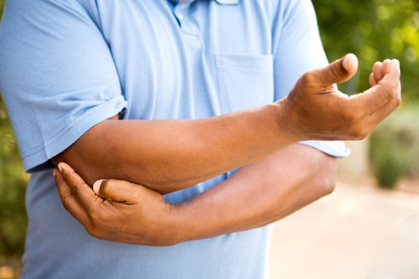 Man pointing to his hurt elbow