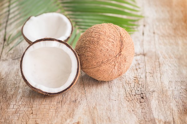 Coconuts sit on a table.