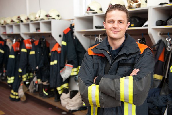 Fire fighter standing in front of their gear