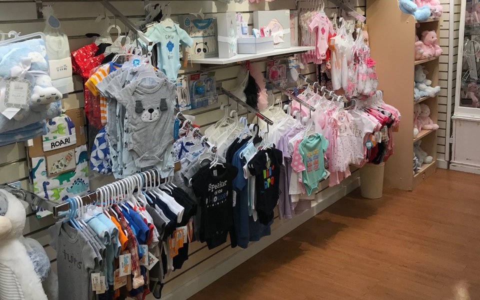 Displays with baby clothes inside the gift shop at Cox South