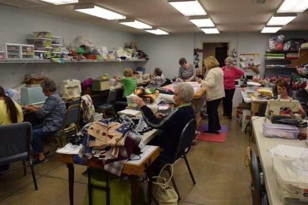 Volunteers sewing quilts.