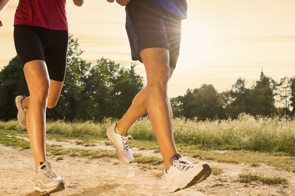 Two runners move down a trail.